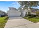 Charming two-story home featuring a two-car garage, a well-manicured lawn, and mature landscaping at 9818 White Barn Way, Riverview, FL 33569