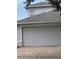 Exterior shot of home's two-car garage door at 9818 White Barn Way, Riverview, FL 33569