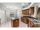 Bright kitchen with a breakfast nook, tiled floors, wood cabinetry, and a functional layout at 9818 White Barn Way, Riverview, FL 33569