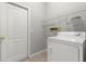 Bright laundry room with washer, dryer, and overhead shelving at 9818 White Barn Way, Riverview, FL 33569