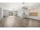 Bright and airy living room featuring wood floors, large windows, and access to the backyard at 9818 White Barn Way, Riverview, FL 33569