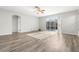 Inviting living space with wood-look floors and sliding glass doors that provide natural light and access to the outdoor pool at 9818 White Barn Way, Riverview, FL 33569
