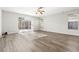 Bright living area with modern flooring and sliding glass doors, offering a seamless transition to the outdoor pool area at 9818 White Barn Way, Riverview, FL 33569