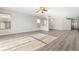 Spacious living area boasting hardwood-style floors, large windows, and an open layout perfect for entertaining and relaxation at 9818 White Barn Way, Riverview, FL 33569