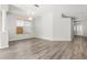 Bright living room with stylish flooring, a decorative chandelier, and an open layout for versatile living spaces at 9818 White Barn Way, Riverview, FL 33569
