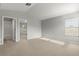 Airy primary bedroom boasts neutral colors, plush carpet, and natural light at 9818 White Barn Way, Riverview, FL 33569
