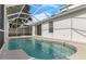 A tranquil pool area, enhanced by a screened enclosure and direct access to the home through sliding glass doors at 9818 White Barn Way, Riverview, FL 33569