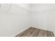Empty walk-in closet featuring wood floors and wire shelving for optimal organization at 9818 White Barn Way, Riverview, FL 33569