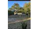 Backyard with chain link fence, trees and a peek of water in the distance at 9900 Ideal Ln, Hudson, FL 34667