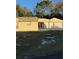 Tan house with red double doors and large two-car garage at 9900 Ideal Ln, Hudson, FL 34667