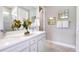 Well-lit bathroom featuring a double vanity with quartz countertops and modern fixtures at 9970 Trellis Vine Way, Parrish, FL 34219