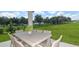 Outdoor patio with dining table and chairs overlooking a green lawn and tree line at 9970 Trellis Vine Way, Parrish, FL 34219