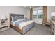 Serene bedroom featuring a plush bed, neutral colors, and a large window with natural light at 9974 Trellis Vine Way, Parrish, FL 34219