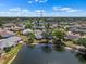 An aerial view showcasing neighborhood homes surrounding a tranquil lake at 1002 Strawpocket Pl, Sun City Center, FL 33573