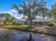 Backyard view of the lake and home featuring an enclosed patio at 1002 Strawpocket Pl, Sun City Center, FL 33573