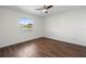 Comfortable bedroom with laminate flooring, lake views, and a ceiling fan for a peaceful environment at 1002 Strawpocket Pl, Sun City Center, FL 33573