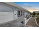 Inviting home exterior showcasing a covered entrance, a garage, and decorative architectural details at 1002 Strawpocket Pl, Sun City Center, FL 33573