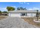 Charming single-story home with a gray brick driveway and manicured landscaping under a bright blue sky at 1002 Strawpocket Pl, Sun City Center, FL 33573