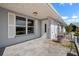 Welcoming front entrance featuring a storm door, a decorative railing, and meticulous landscaping at 1002 Strawpocket Pl, Sun City Center, FL 33573