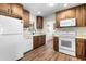 Well-lit kitchen featuring modern appliances, wood cabinets, and a stylish backsplash for a contemporary cooking experience at 1002 Strawpocket Pl, Sun City Center, FL 33573