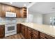 Spacious kitchen with ample counter space, wood cabinetry, and modern appliances, ideal for culinary enthusiasts at 1002 Strawpocket Pl, Sun City Center, FL 33573