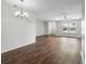 Inviting living area featuring laminate floors, a ceiling fan, and an open layout for versatile living at 1002 Strawpocket Pl, Sun City Center, FL 33573