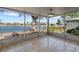 Enclosed patio with tile flooring and fan providing beautiful views of the lake at 1002 Strawpocket Pl, Sun City Center, FL 33573