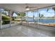 Enclosed patio featuring tile floor and a ceiling fan overlooking the serene lake view at 1002 Strawpocket Pl, Sun City Center, FL 33573