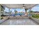 Enclosed patio with tile floor and a ceiling fan offering serene lake views at 1002 Strawpocket Pl, Sun City Center, FL 33573