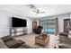 Open living room with tile flooring, ceiling fan, and sliding glass doors leading to the pool at 10119 Briar Cir, Hudson, FL 34667