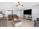 Bright living room featuring tile flooring and a ceiling fan and comfortable seating at 10119 Briar Cir, Hudson, FL 34667