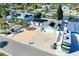 Aerial view of a single Gathering home featuring a large driveway, solar panels, and a parked RV at 1015 Spindle Palm Way, Apollo Beach, FL 33572