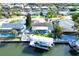An aerial view of a waterfront property showcasing a private boat lift and the surrounding neighborhood at 1015 Spindle Palm Way, Apollo Beach, FL 33572