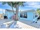 This home features a spacious backyard with a deck, lush landscaping, and a grill at 1015 Spindle Palm Way, Apollo Beach, FL 33572