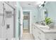 Charming bathroom featuring marble countertop, vanity, tiled floors, and tiled shower at 1015 Spindle Palm Way, Apollo Beach, FL 33572