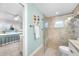 Charming bathroom with tiled shower and glass door, next to the primary bedroom at 1015 Spindle Palm Way, Apollo Beach, FL 33572