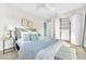 Stylish bedroom with wood-look floors, ceiling fan, and a closet with organizers at 1015 Spindle Palm Way, Apollo Beach, FL 33572
