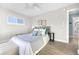 Relaxing bedroom featuring a ceiling fan, wood-look floors, and ensuite bathroom at 1015 Spindle Palm Way, Apollo Beach, FL 33572