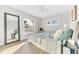 Sun-filled bedroom with wood-look floors and large mirror with views of the yard at 1015 Spindle Palm Way, Apollo Beach, FL 33572