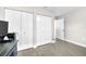 Bedroom with closet doors, light walls, base trim, and tile flooring at 1015 Spindle Palm Way, Apollo Beach, FL 33572