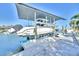 Boat on a lift over a canal with views of neighboring docks at 1015 Spindle Palm Way, Apollo Beach, FL 33572