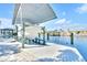 Covered boat lift on a canal behind a property with waterfront access at 1015 Spindle Palm Way, Apollo Beach, FL 33572