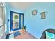 Warm and inviting home entryway with attractive decor, tiled floor, and blue walls at 1015 Spindle Palm Way, Apollo Beach, FL 33572