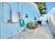 Bright blue house with hose, outdoor grill, and view of the backyard and canal at 1015 Spindle Palm Way, Apollo Beach, FL 33572