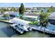 Beautiful waterfront home featuring a private boat lift, lush landscaping, and serene water views at 1015 Spindle Palm Way, Apollo Beach, FL 33572