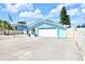 Light blue home with a two-car garage, ample parking, and well-kept landscaping at 1015 Spindle Palm Way, Apollo Beach, FL 33572
