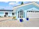 Close up of home featuring a two car garage and arched, screened entry way at 1015 Spindle Palm Way, Apollo Beach, FL 33572