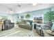 Bright and airy living room with ceiling fans, plenty of seating, and serene ambiance at 1015 Spindle Palm Way, Apollo Beach, FL 33572