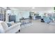 Open-concept living space with a home office, kitchen island, and cozy seating areas at 1015 Spindle Palm Way, Apollo Beach, FL 33572