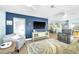Comfortable living room with updated furnishings, blue accent wall, and open to dining and kitchen area at 1015 Spindle Palm Way, Apollo Beach, FL 33572
